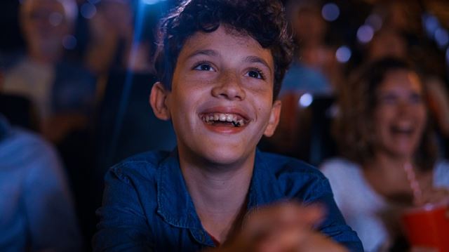 Boy smiling in cinema